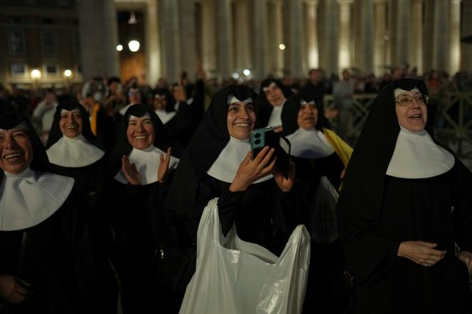 مجموعة من الراهبات يرون الدخان الأسود يخرج من مصلى كنيسة سيستين ، مكان سانت بيير ، في روما ، الأربعاء 7 مايو 2025.