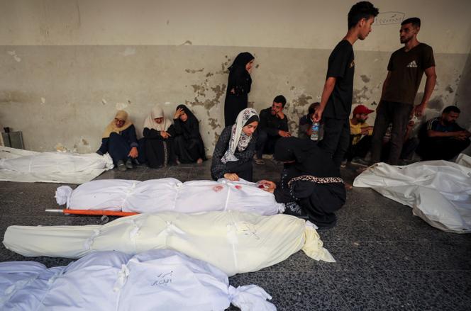 يتجمع أقارب الحداد بالقرب من جثث الأشخاص الذين قتلوا بسبب قصف إسرائيلي على مسكن مدرسي نازح ، في مستشفى الأهلي ، في مدينة غزة ، في 5 يوليو 2025. 