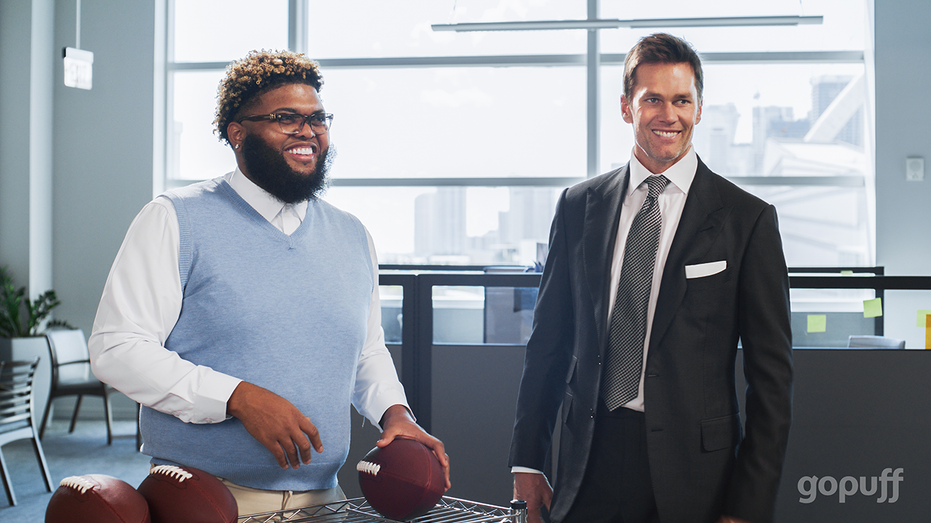 توم برادي ودروسكي ينظران إلى كرات القدم