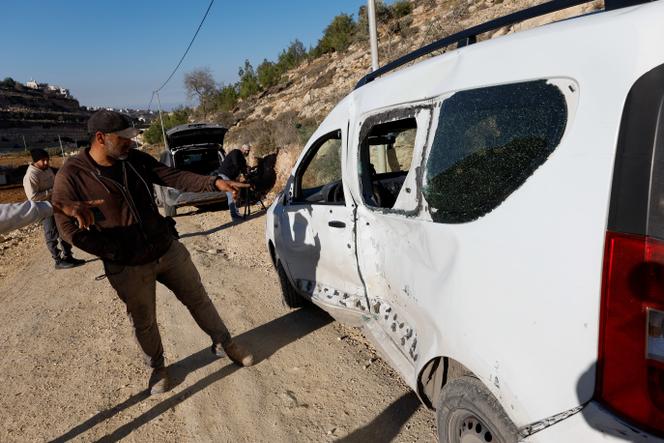 يشير الناس إلى مركبة مدمرة، بعد أن أطلقت القوات الإسرائيلية النار وقتلت سائقها البالغ من العمر 17 عامًا، والذي قال الجيش الإسرائيلي إنه صدم جنودًا بسيارته، في الخليل، الضفة الغربية، الثلاثاء 2 ديسمبر 2025. 